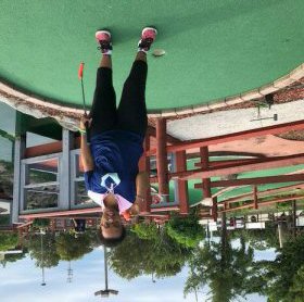 Elshu scoring hole in one at mini-golf